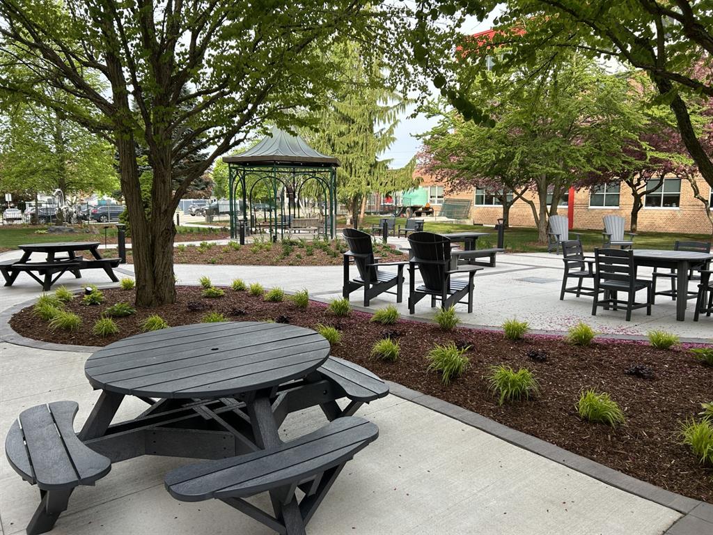 Picnic table and chairs in the foreground and gazebo in the background.